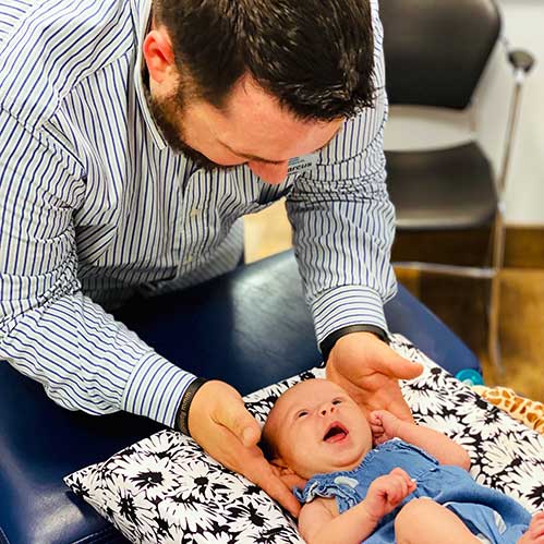 Chiropractor Leland NC Dr. Marcus Woodburn and Infant Patient
